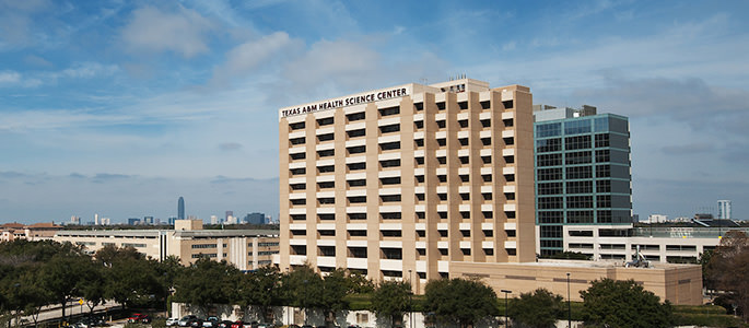 Houston campus building with Houston skyline in the background